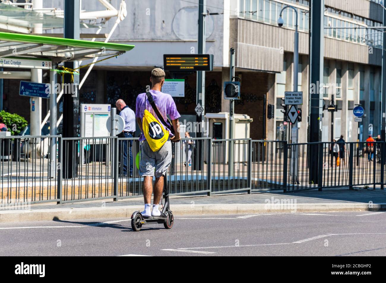 Electric Scooter ridden by a young male near East Croydon station, London Stock Photo