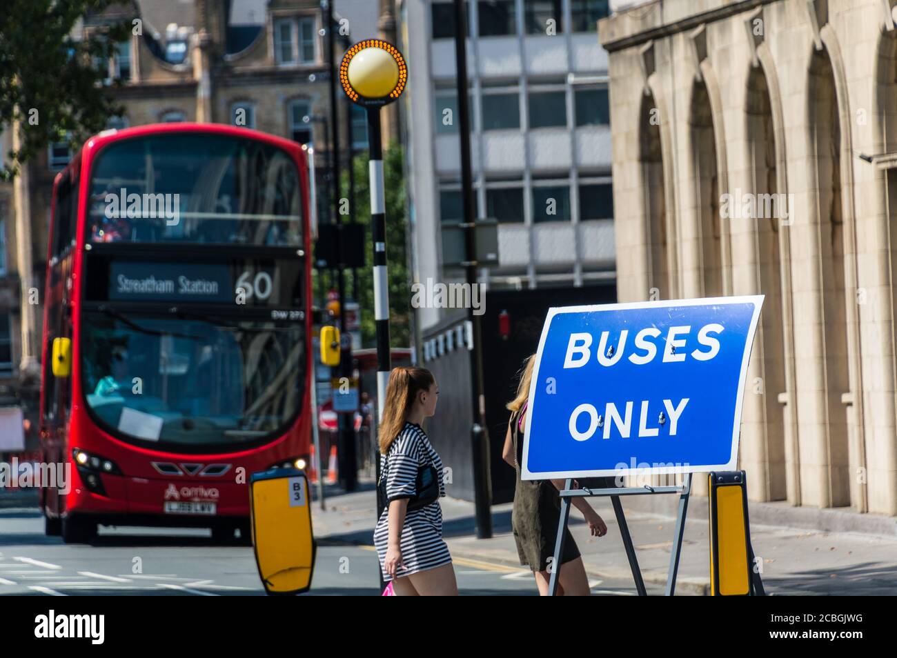 Buses only blue sign board with a red london bus in background Stock Photo