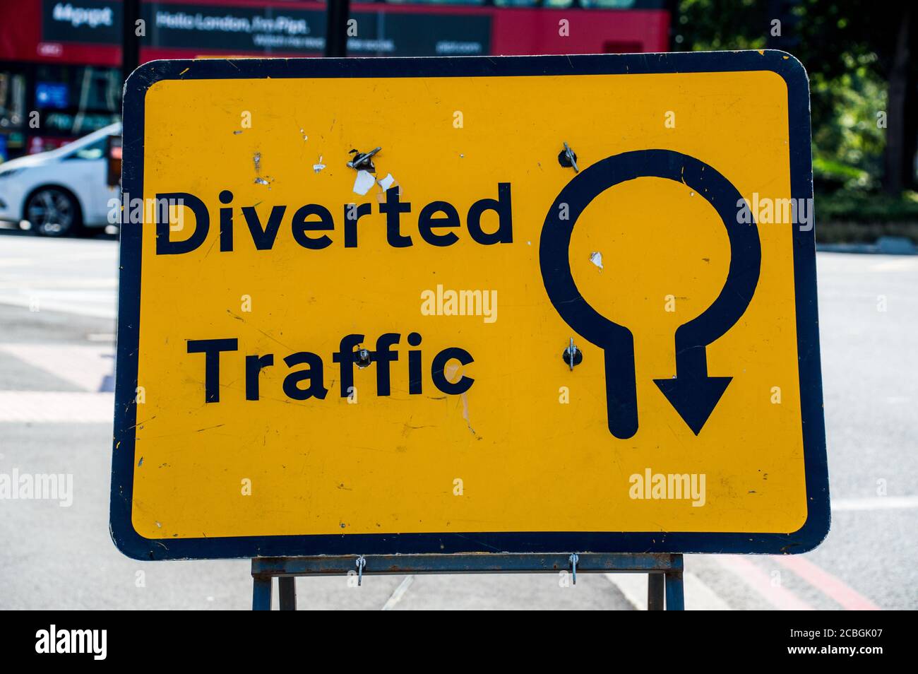 Diverted Traffic sign board to go around in round about Stock Photo