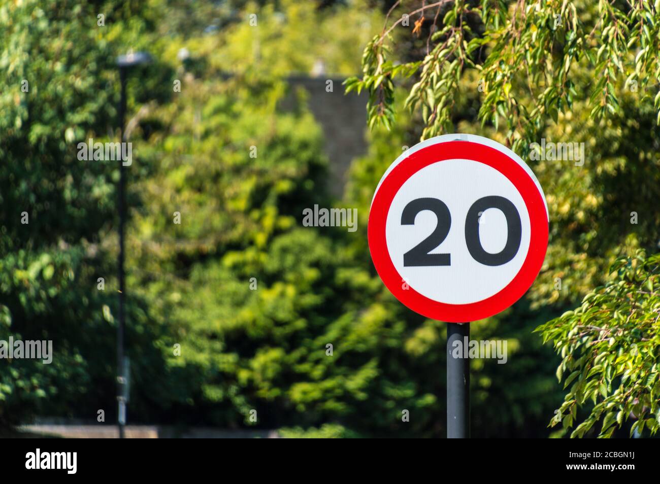 20 mph sign (Miles Per Hour) British road speed limit sign on residential built up area Stock Photo