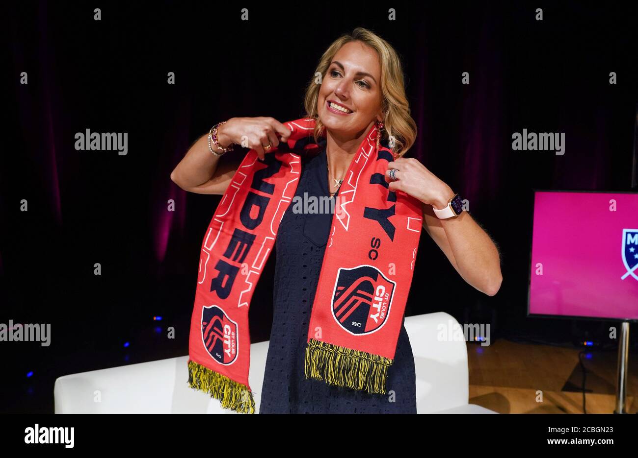 A St. Louis City SC fan holds up a scarf before the first game for the