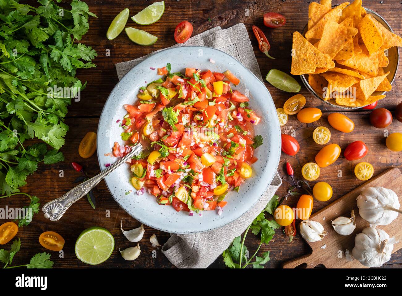 Tex Mex Pico de Gallo with nacho tortilla chips. The bowl of tomato