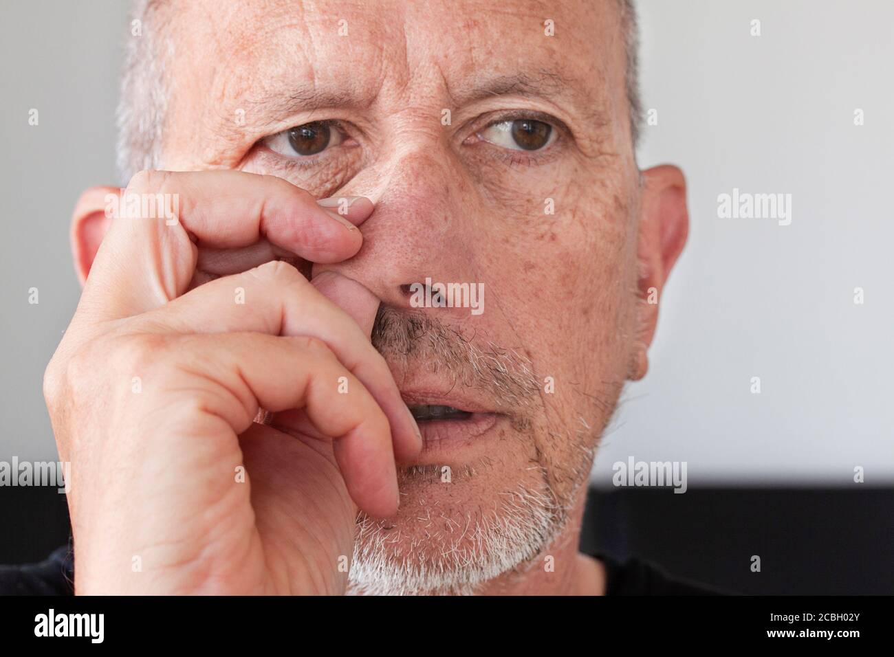 https://c8.alamy.com/comp/2CBH02Y/senior-man-with-unshaved-stubble-beard-picking-his-nose-thumb-up-in-his-nostril-close-up-image-2CBH02Y.jpg