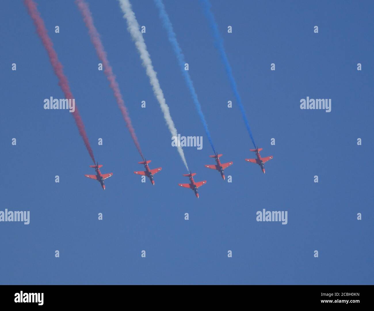 The world-famous Red Arrows aerobatics display team put on an incredible display over Anglesey today.  The team held a training rehearsal over RAF Valley in Anglesey, ahead of a number of fly-pasts this weekend for the Victory in Japan Day services. Credit Ian Fairbrother/Alamy Stock Photos Stock Photo