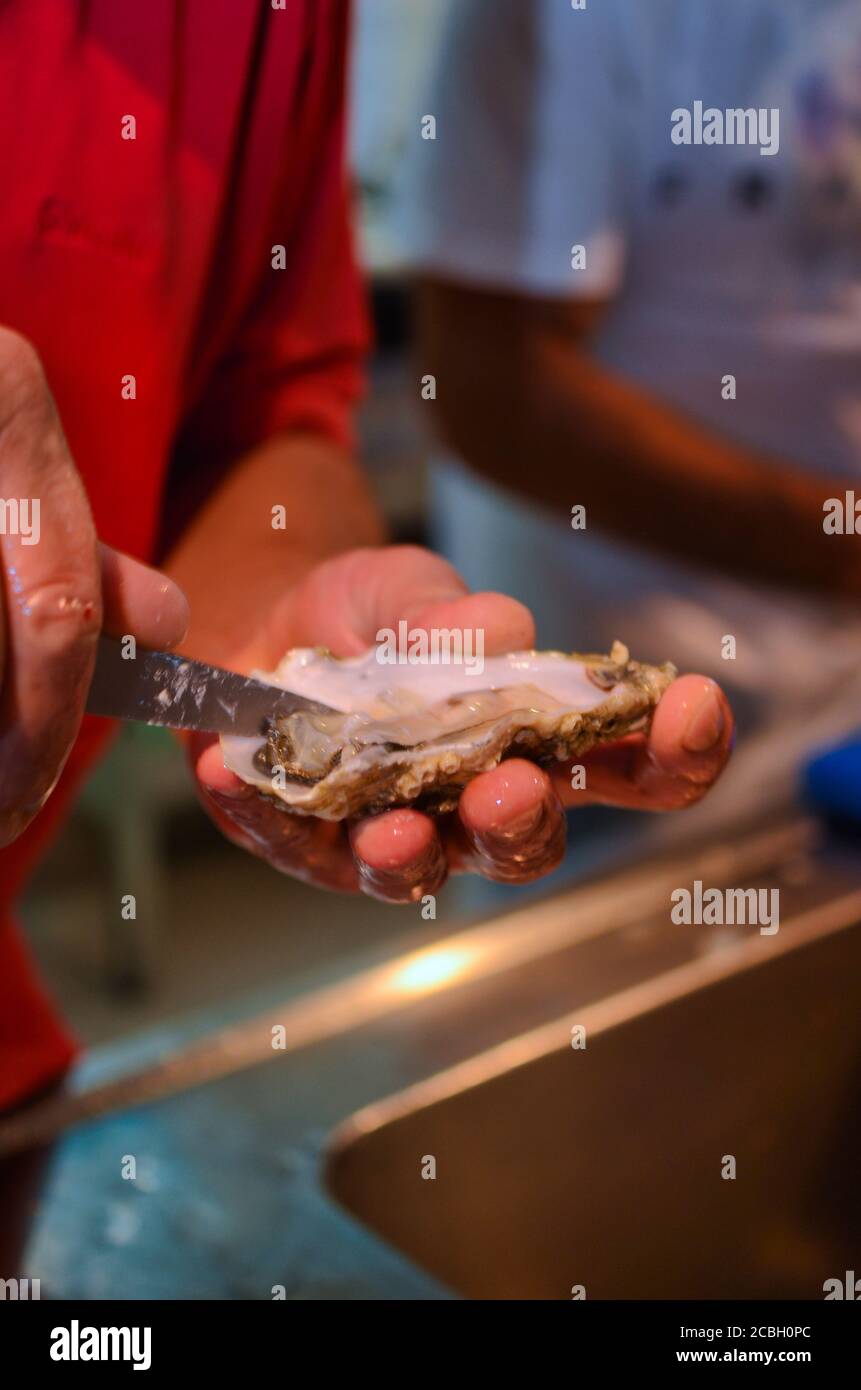 Italy - August 2020 at the fish market butcher works cleaning and ...
