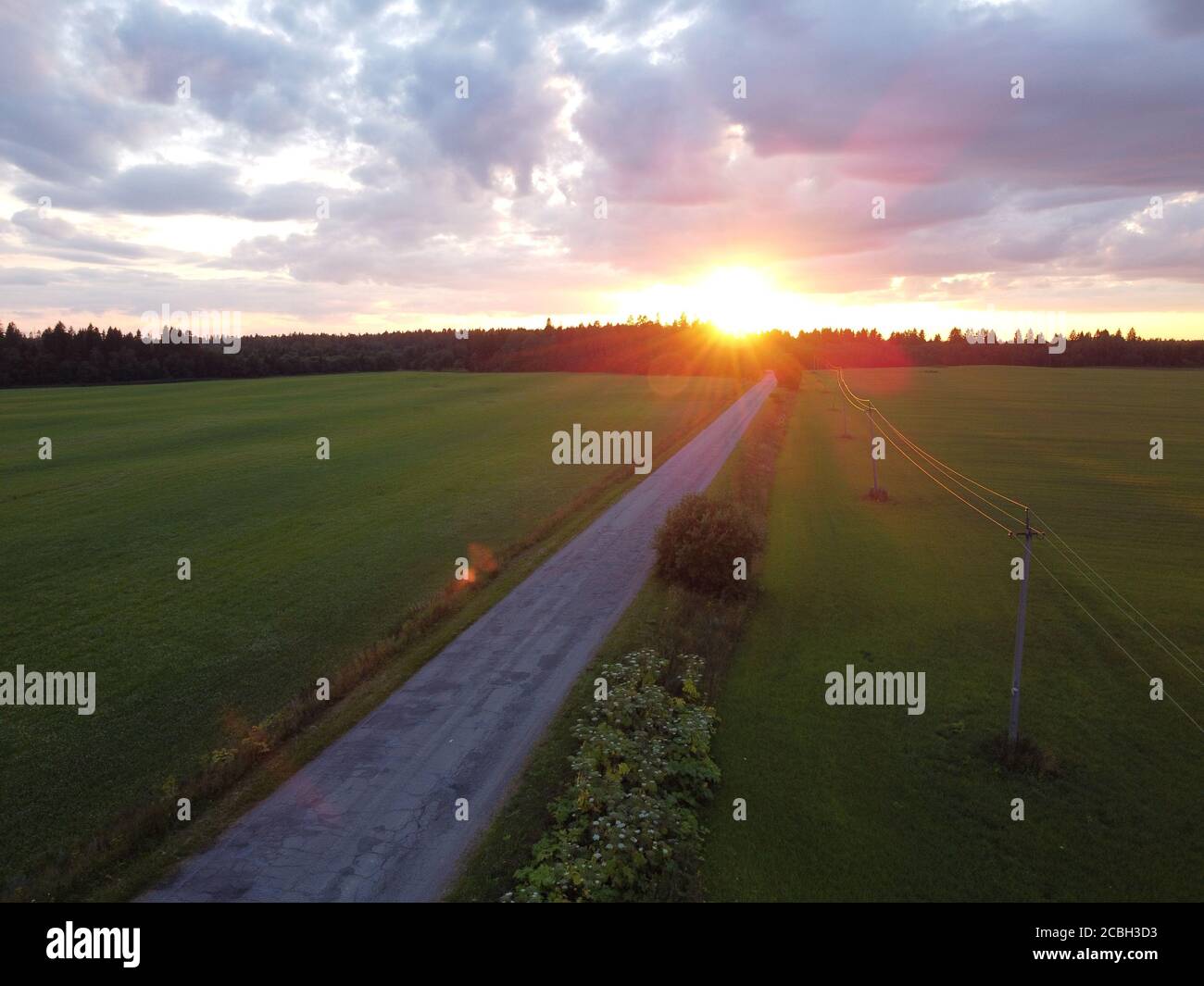 old car road at sunset in summer aerial photography Stock Photo