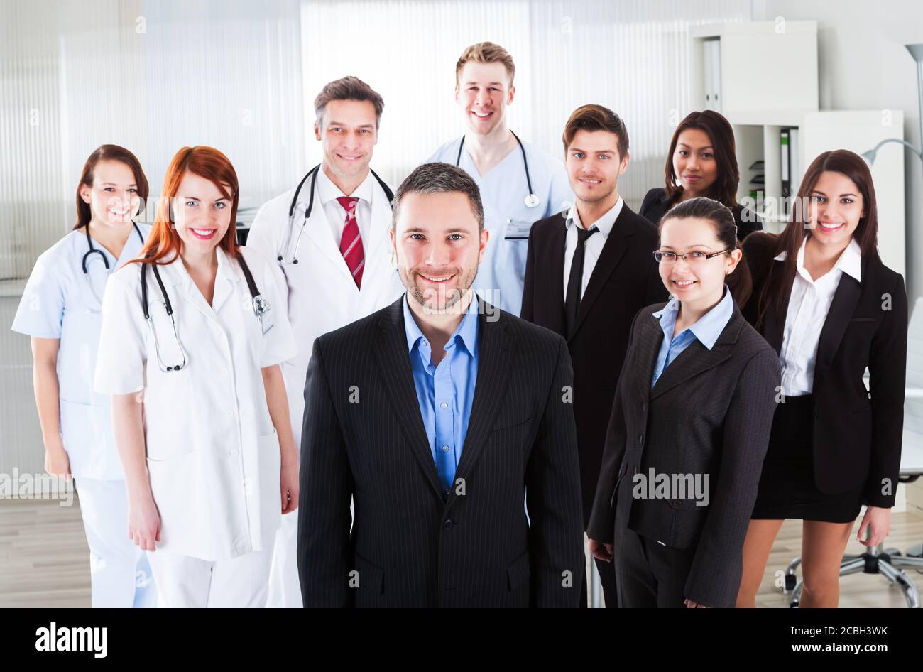 Portrait Of Group Of Business People Confidently Standing Together Stock Photo