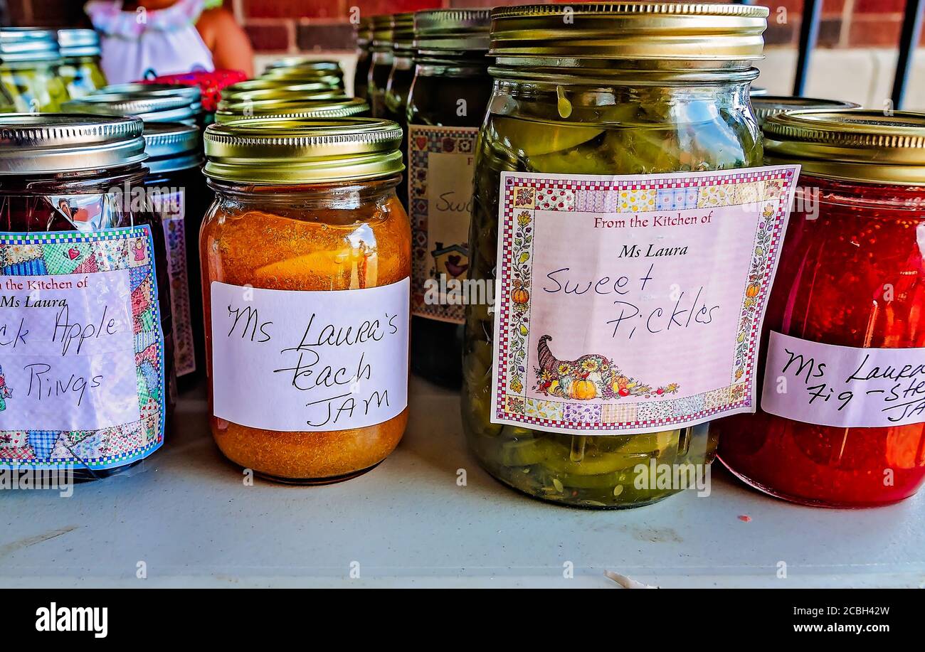Peach jam, mock apple rings, and other fruit preserves are lined up at a vendor’s booth at the Clarksdale Farmers Market in Clarksdale, Mississippi. Stock Photo