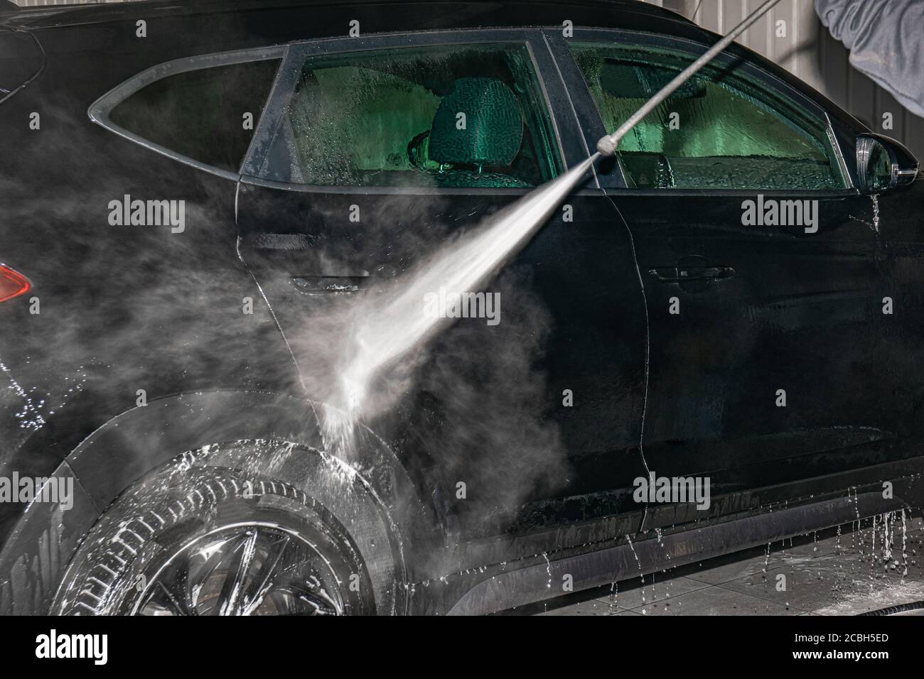 Car foam washing, black car side cleaning with a highpressure foam gun