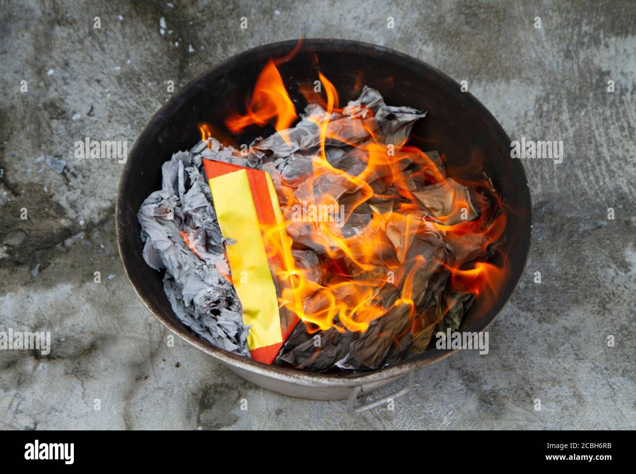 Fire burning gold paper fake respect to pay predecessor in Chinese New Year festival. Stock Photo