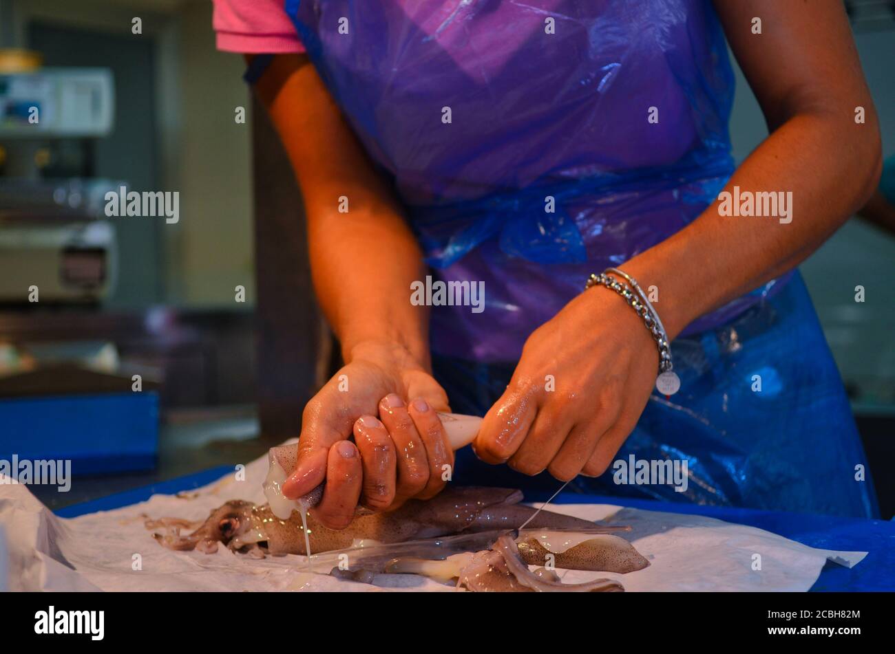 Italy - August 2020 at the fish market butcher works cleaning and ...
