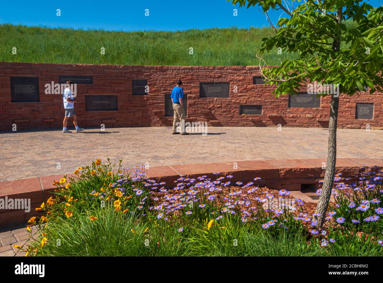 Visitors at beautiful Columbine High School Memorial read plaques, Littleton Colorado US.1999, the year of the first school mass shooting in history. Stock Photo