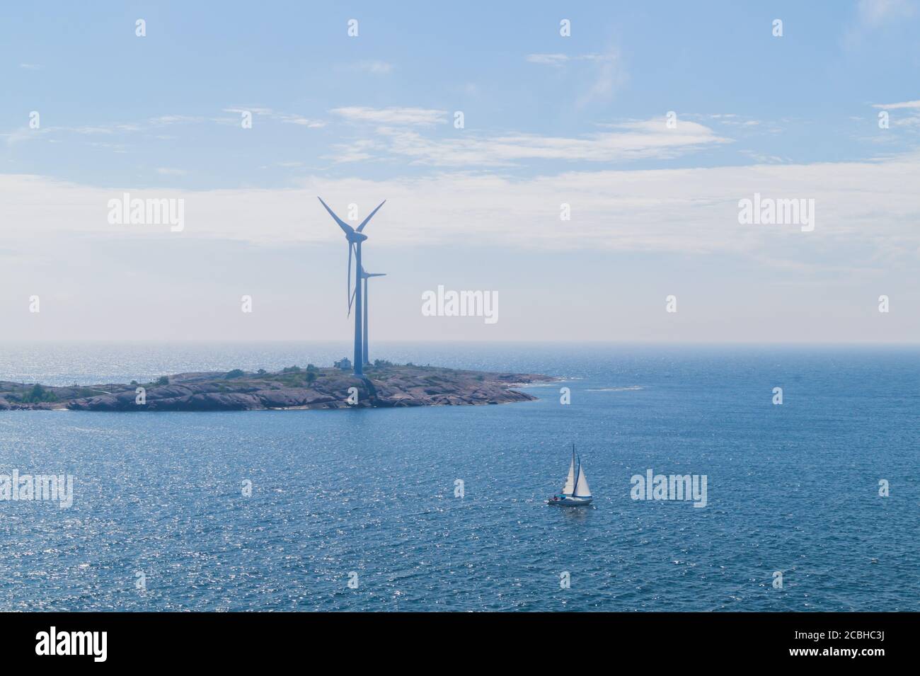 Windmill on an island in the sea. wind generator for generating
