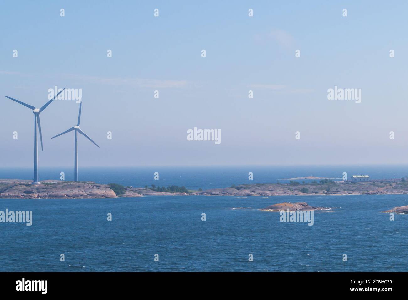 Windmill on an island in the sea. wind generator for generating