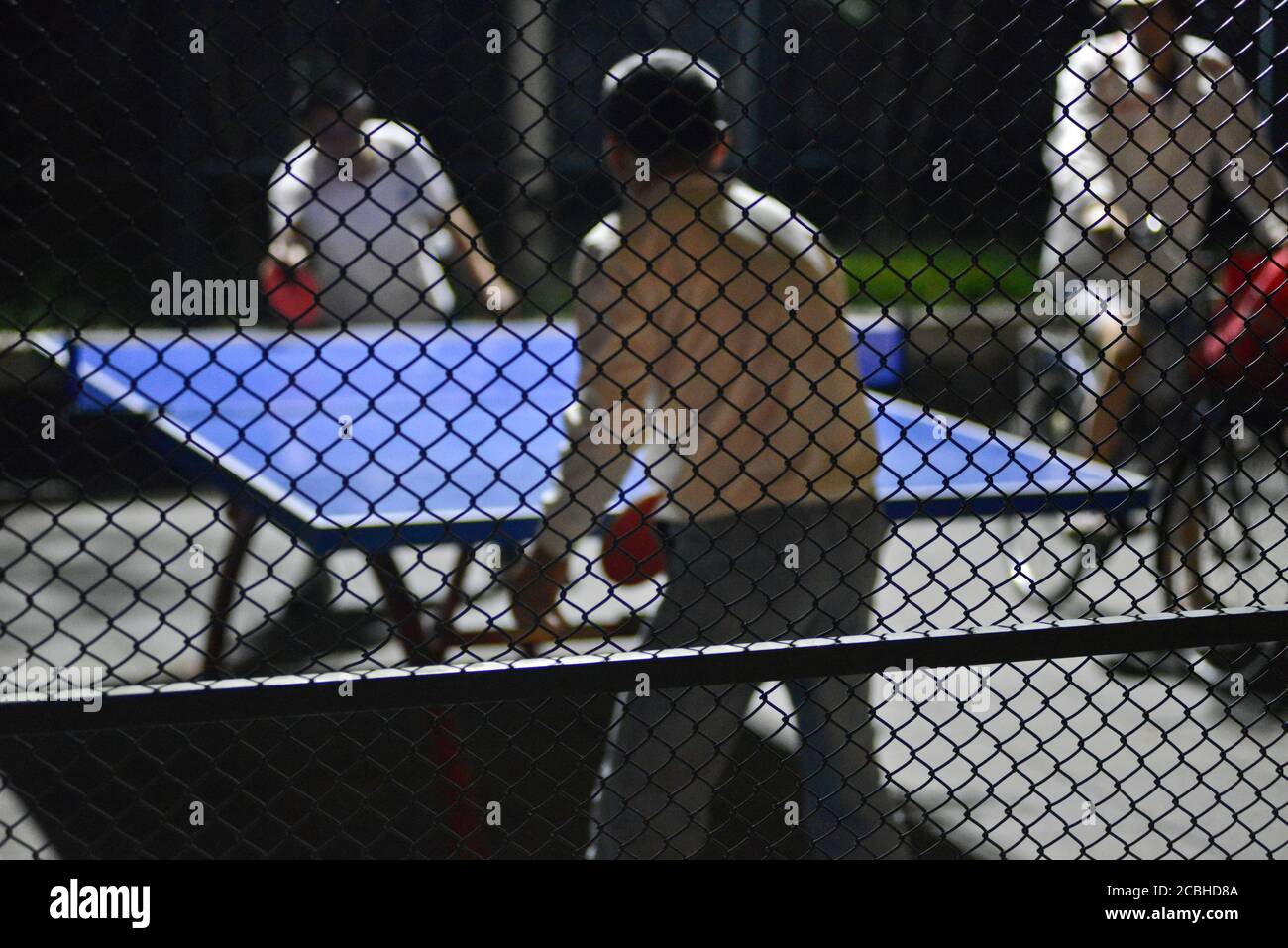 Chinese men playing table tennis in a public park, Beijing, China Stock Photo
