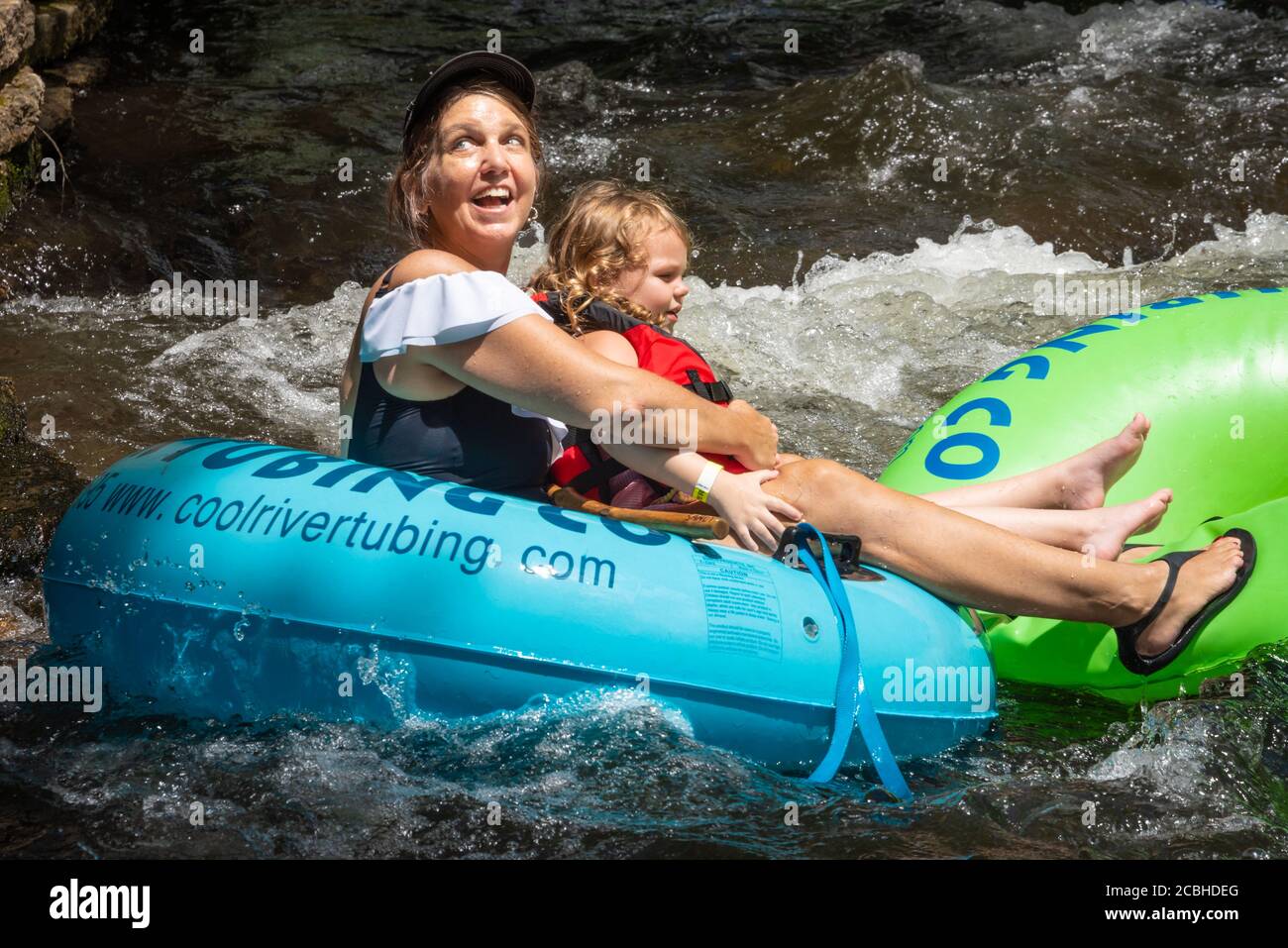 Happy woman and child tubing together on the Chattahoochee River in the North Georgia Mountains at Helen, Georgia. (USA) Stock Photo