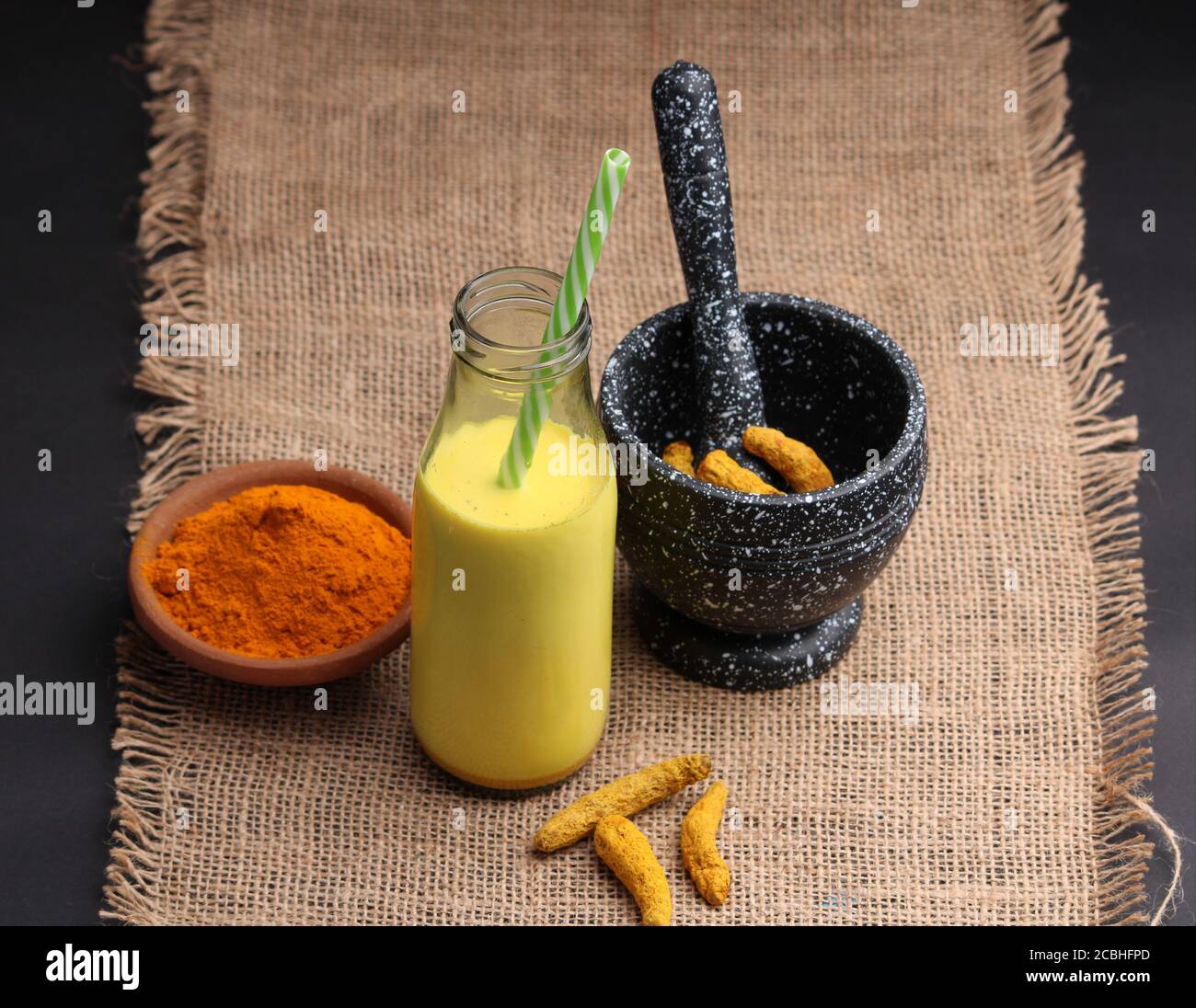 Turmeric drink, latte, tea, milk with cinnamon in a glass mug with