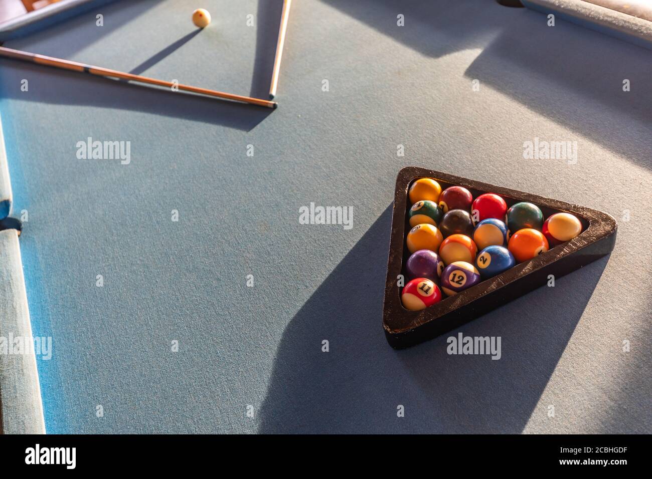 Billiard balls in a pool table in abstract light. Billiard balls in a green pool table, game. Billiard table with cue and balls. Snooker billiard game Stock Photo