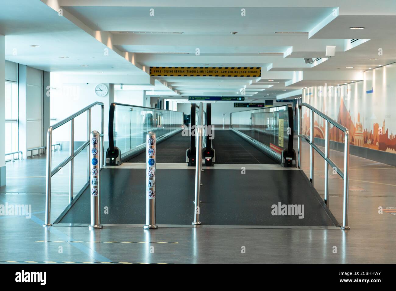 A travelator in an empty airport corridor during the coronavirus pandemic Stock Photo