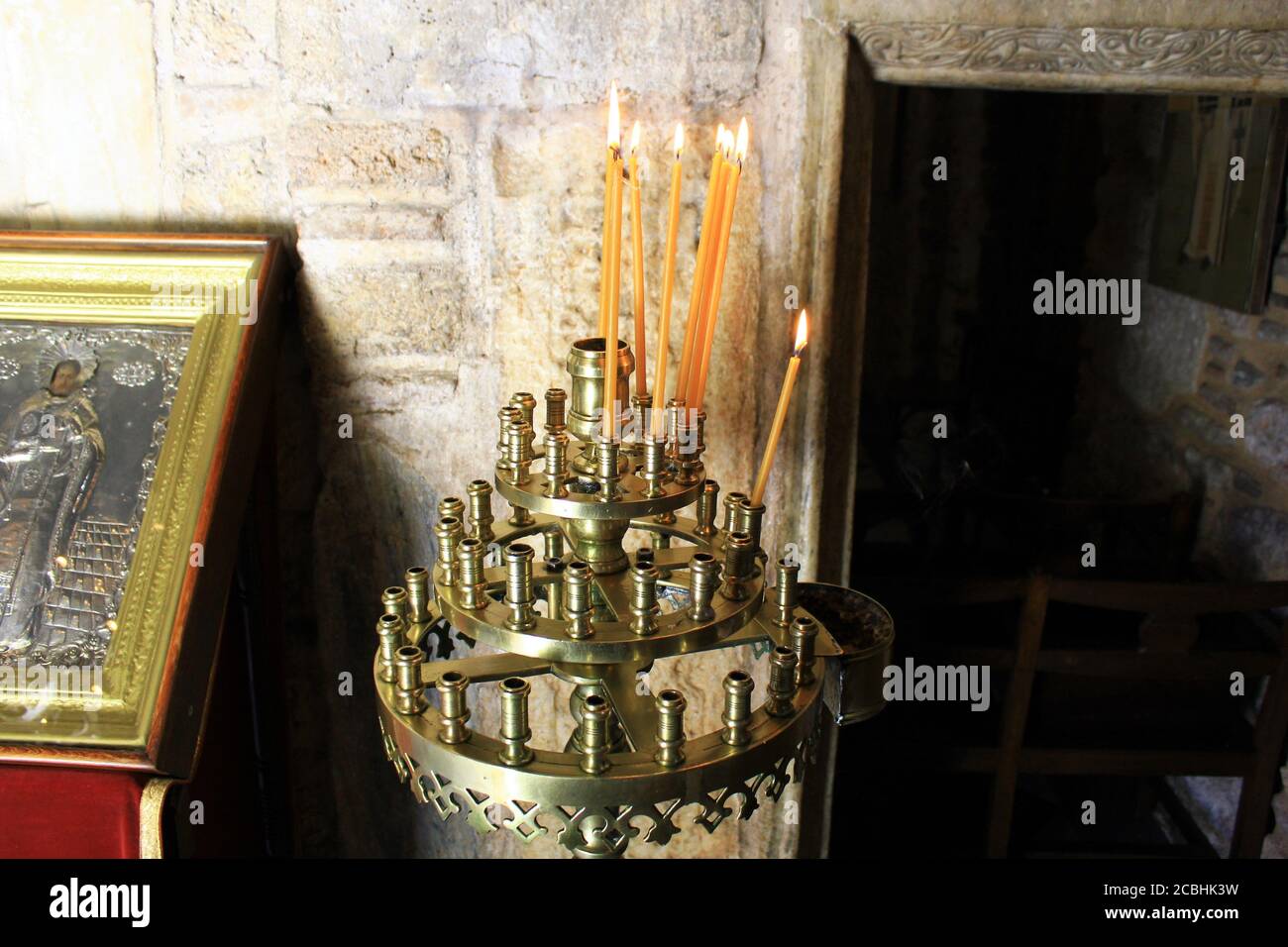 Lighting candles inside a Greek orthodox church Stock Photo Alamy