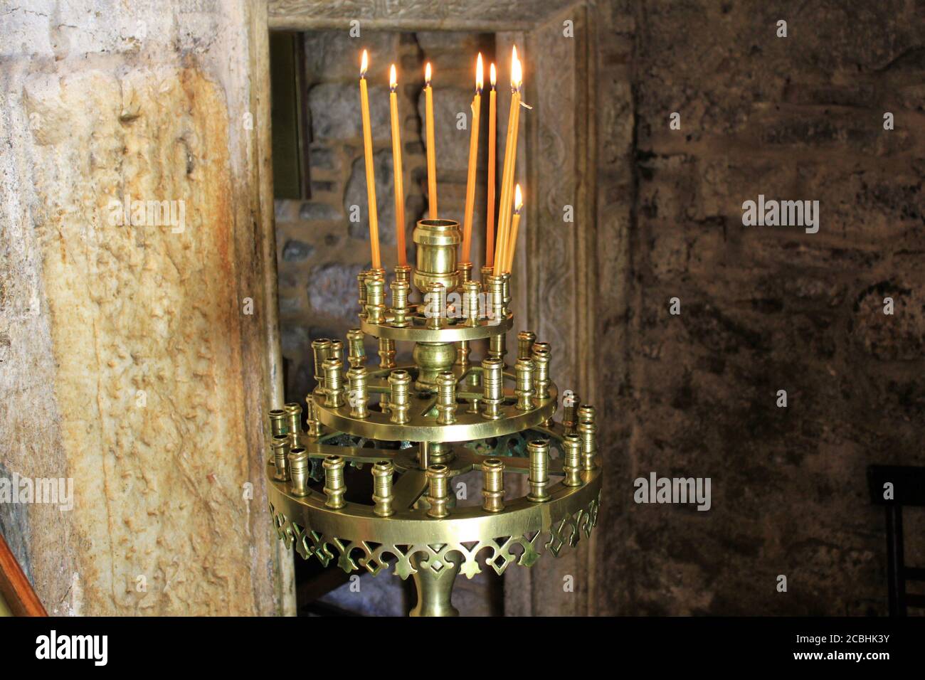 Lighting candles inside a Greek orthodox church Stock Photo - Alamy