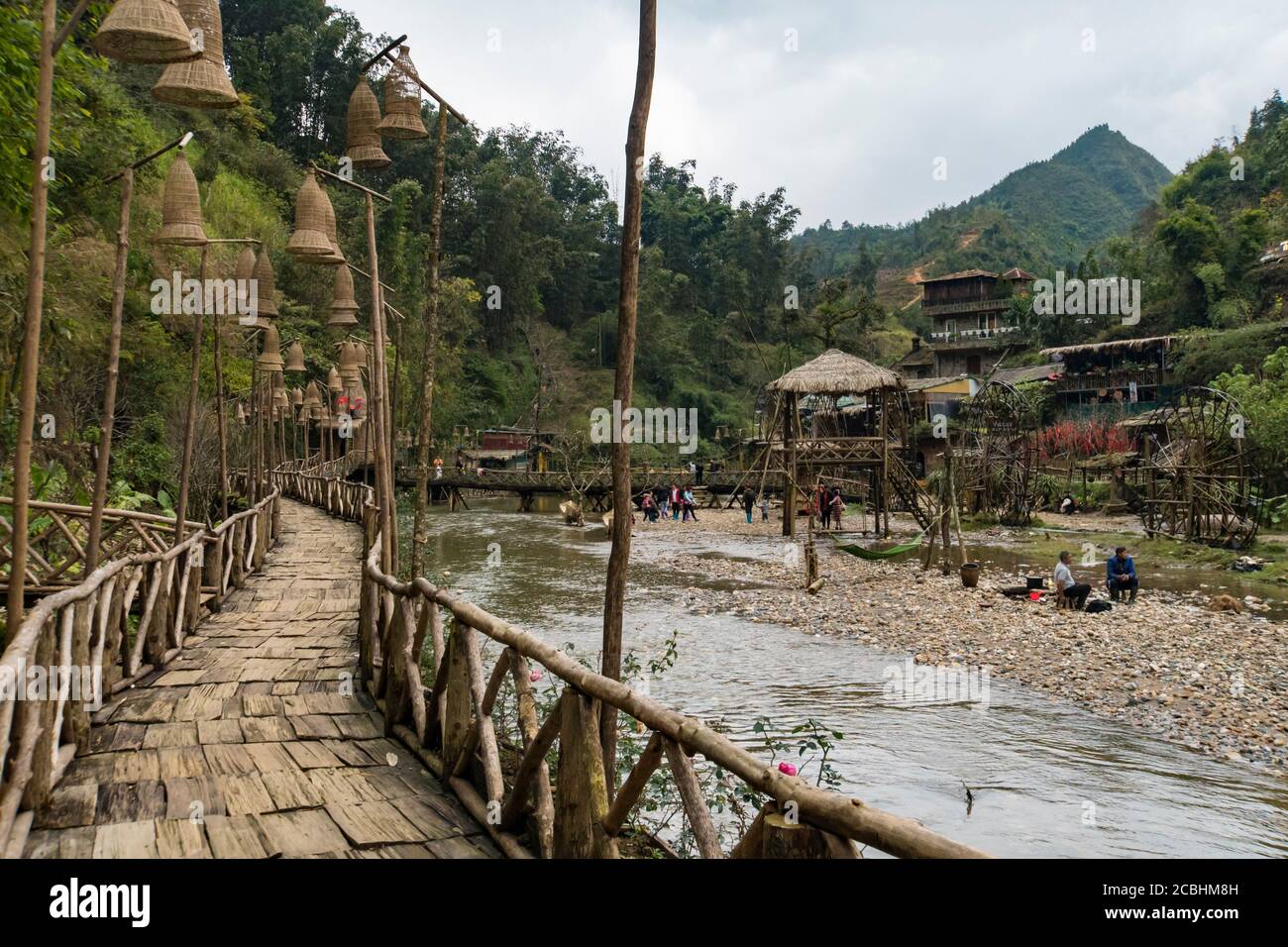 Cat Cat, Vietnam - 11 January 2019: Cat Cat ethnic village landscape with waterfall and tourists exploring the area Stock Photo