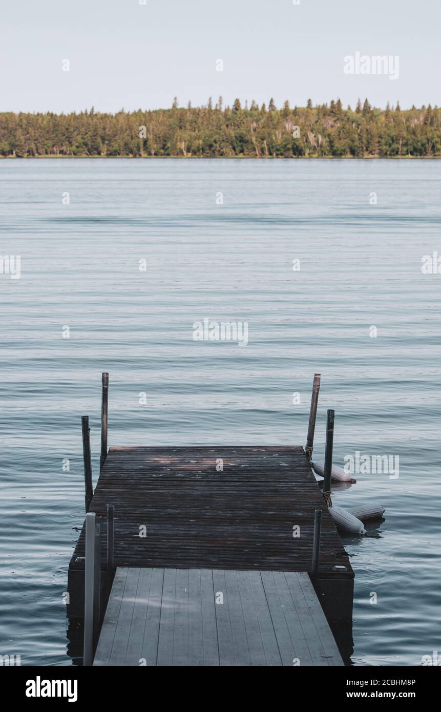 Calm morning on a dock on Child's Lake in Duck Mountain Provincial Park, Manitoba, Canada Stock Photo