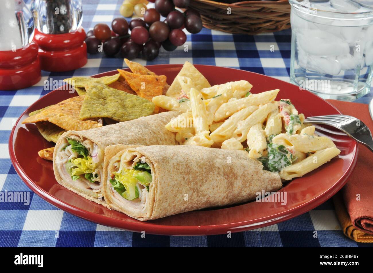 Turkey or chicken wrap sandwiches with mozzarella pasta salad and vegetable  tortilla chips Stock Photo - Alamy