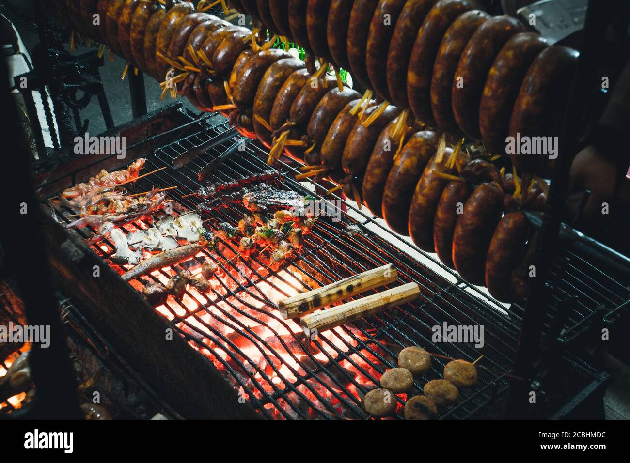 Smoked sausage hanging over the grill. The process of Smoking sausage