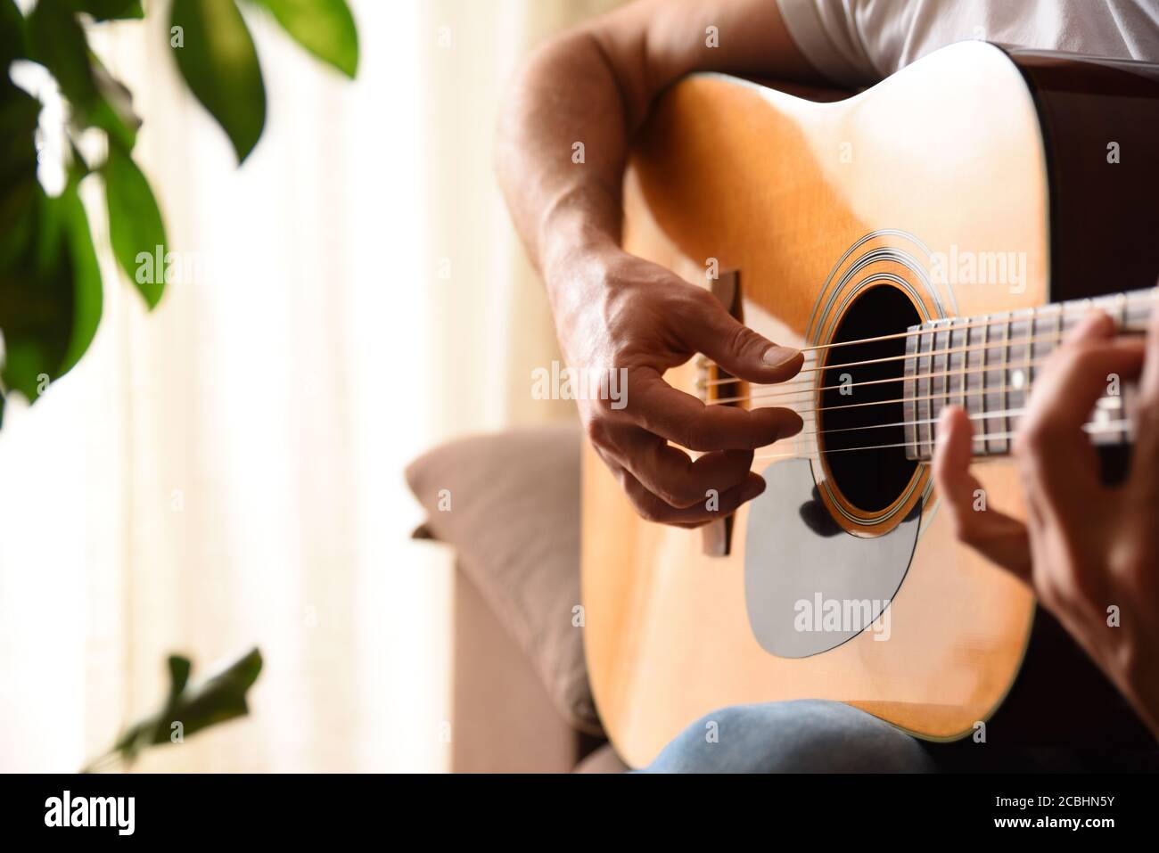 Acoustic guitar body background and hands playing with background and warm atmosphere Stock Photo