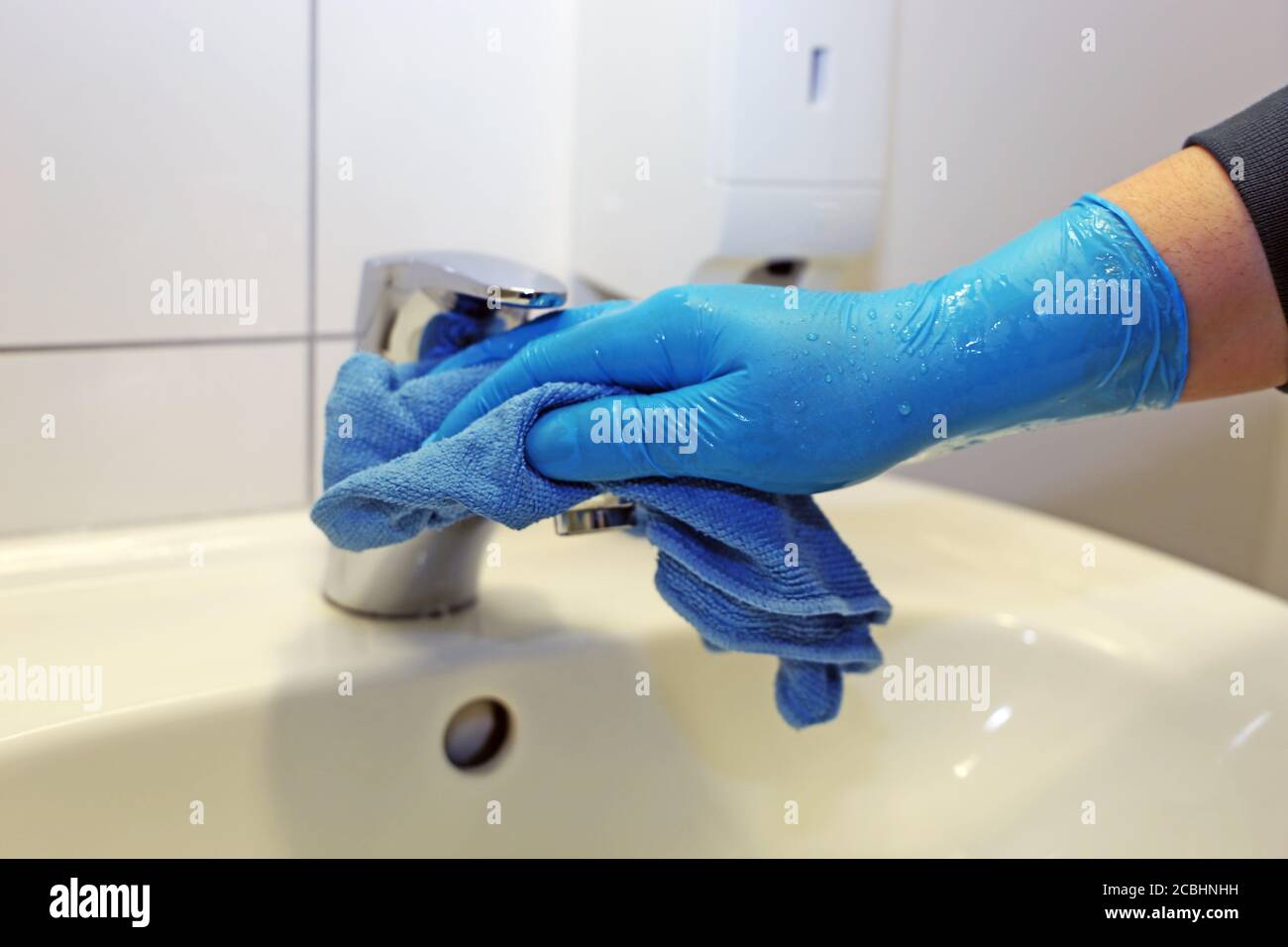 Cleaning and disinfection of a wash basin Stock Photo