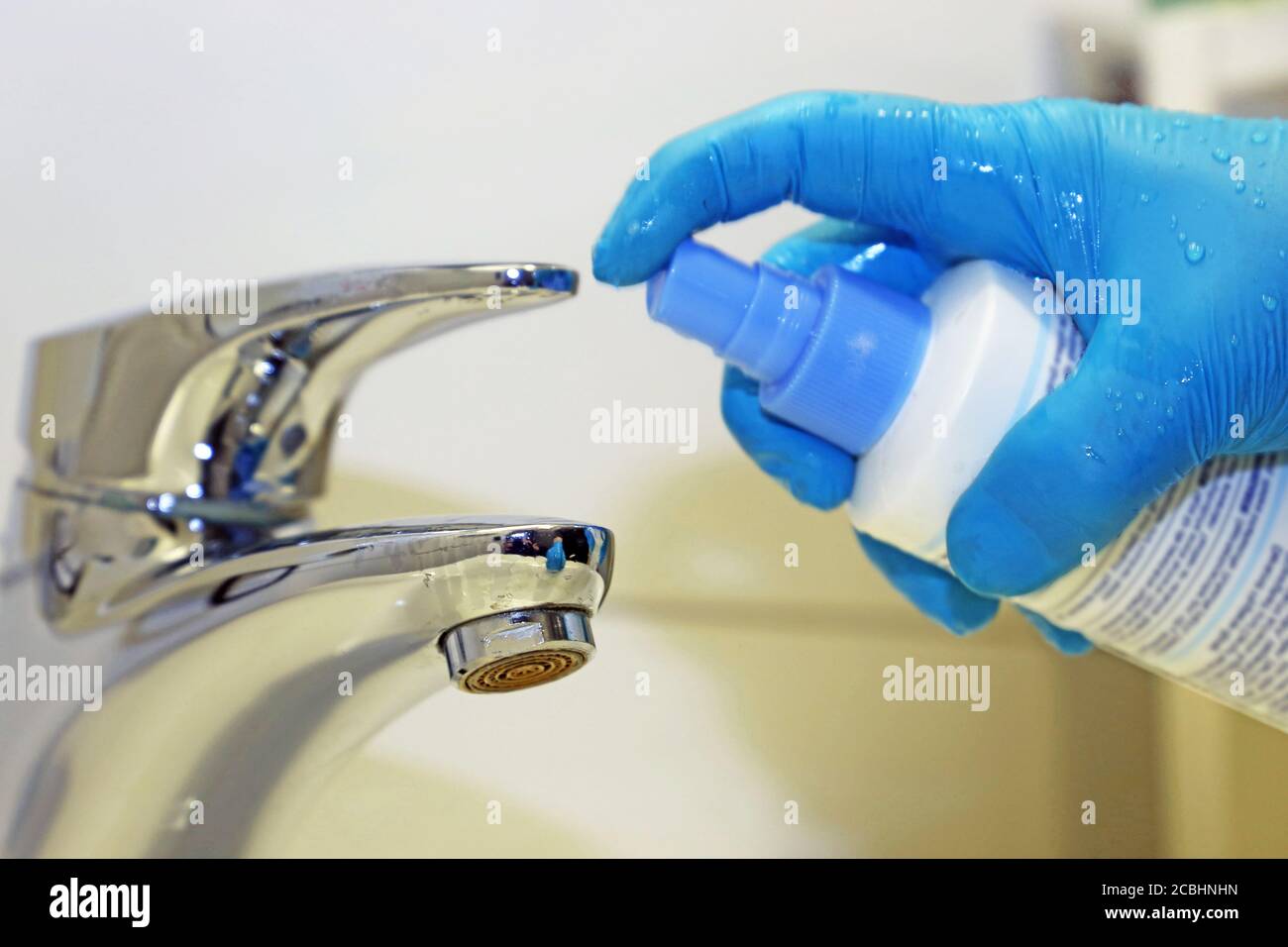 Cleaning and disinfection of a wash basin Stock Photo