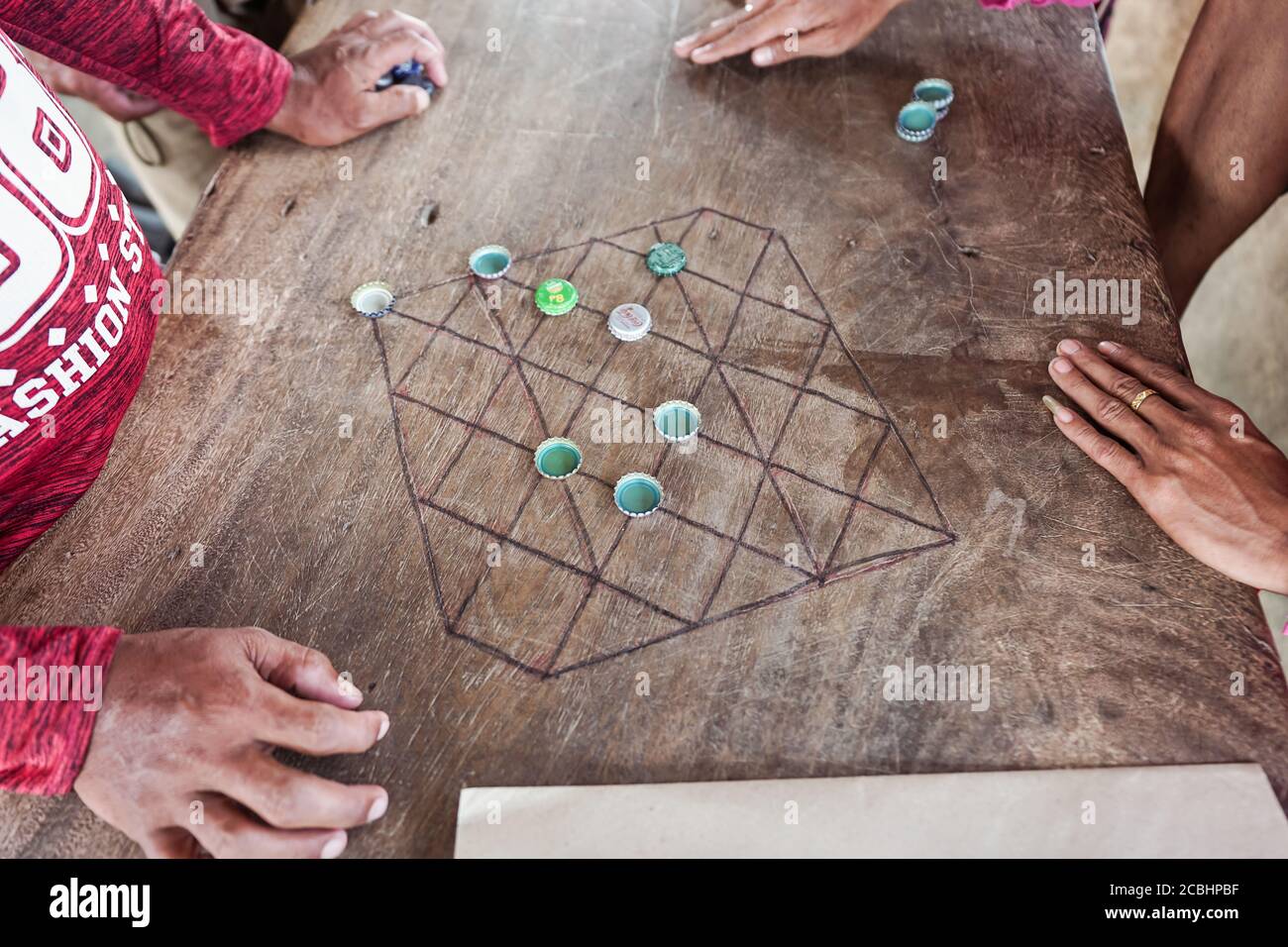 Bohol / Philippines July 18, 2019 Filipino men playing board game