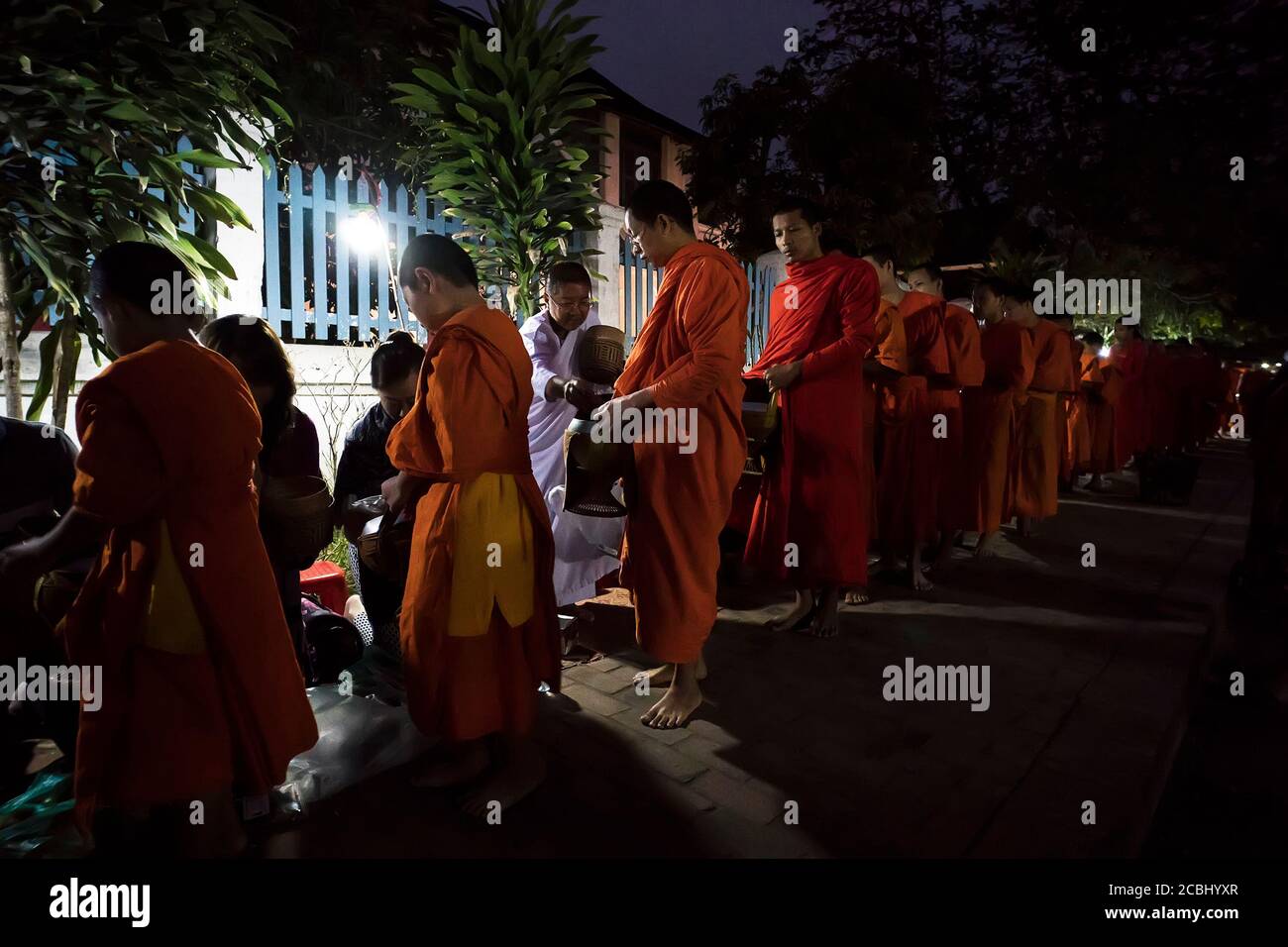 Luang Prabang, Laos - Jun 14, 2019 - Laos Buddhist alms giving sticky rice ceremony in the morning, The tradition of giving alms to monks in Luang Stock Photo