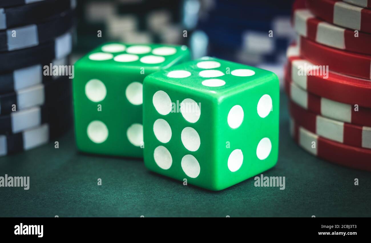 Playing dice and poker chips stacks, close up view Stock Photo