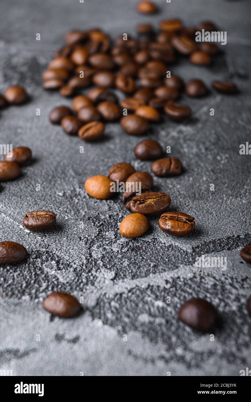 Roasted coffee beans on grey textured background Stock Photo - Alamy