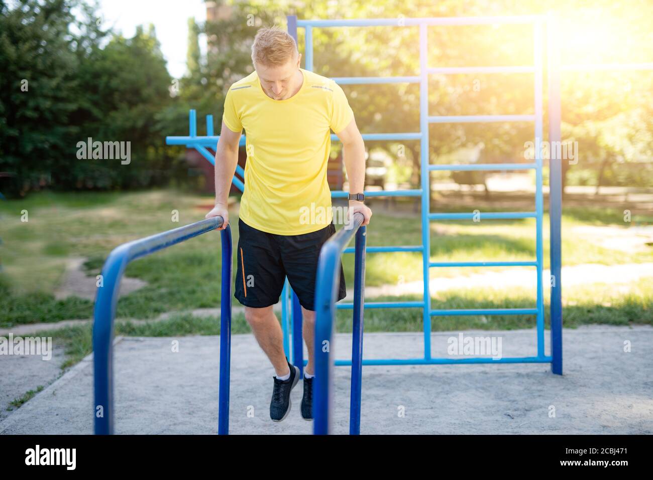 Muscular athlete training on parallel hi-res stock photography and ...