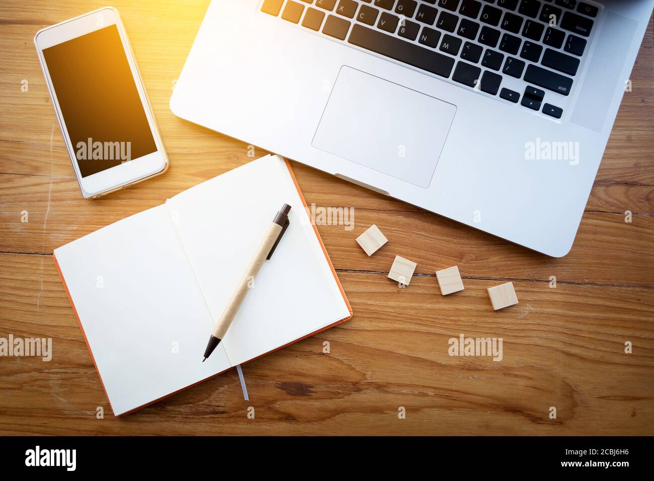 Workspace top view for background concept : Wooden work desk top view with laptop , smartphone and notebook with copyspace. film effect Stock Photo