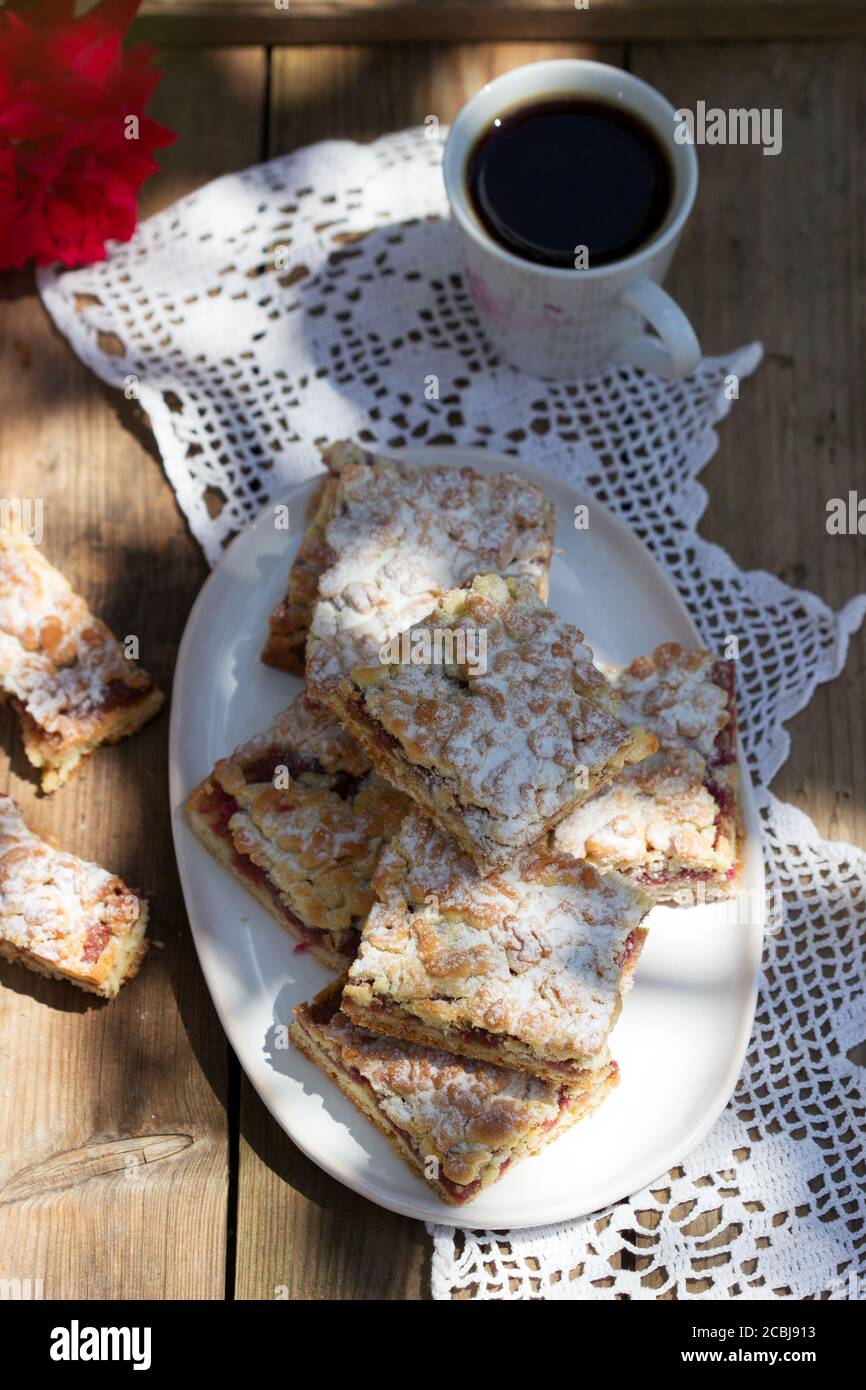 Streusel pie stuffed with rose jam, served with coffee. Rustic style. Stock Photo