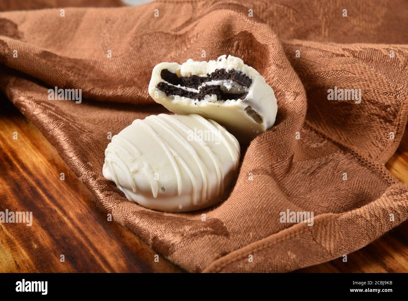 Cream filled sandwich cookies dipped in white chocolate Stock Photo Alamy