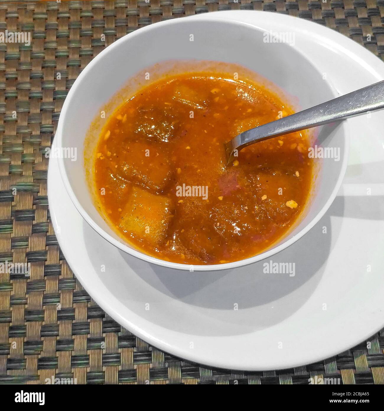 HOT AND SPICY SOUP ON WHITE BOWL Stock Photo