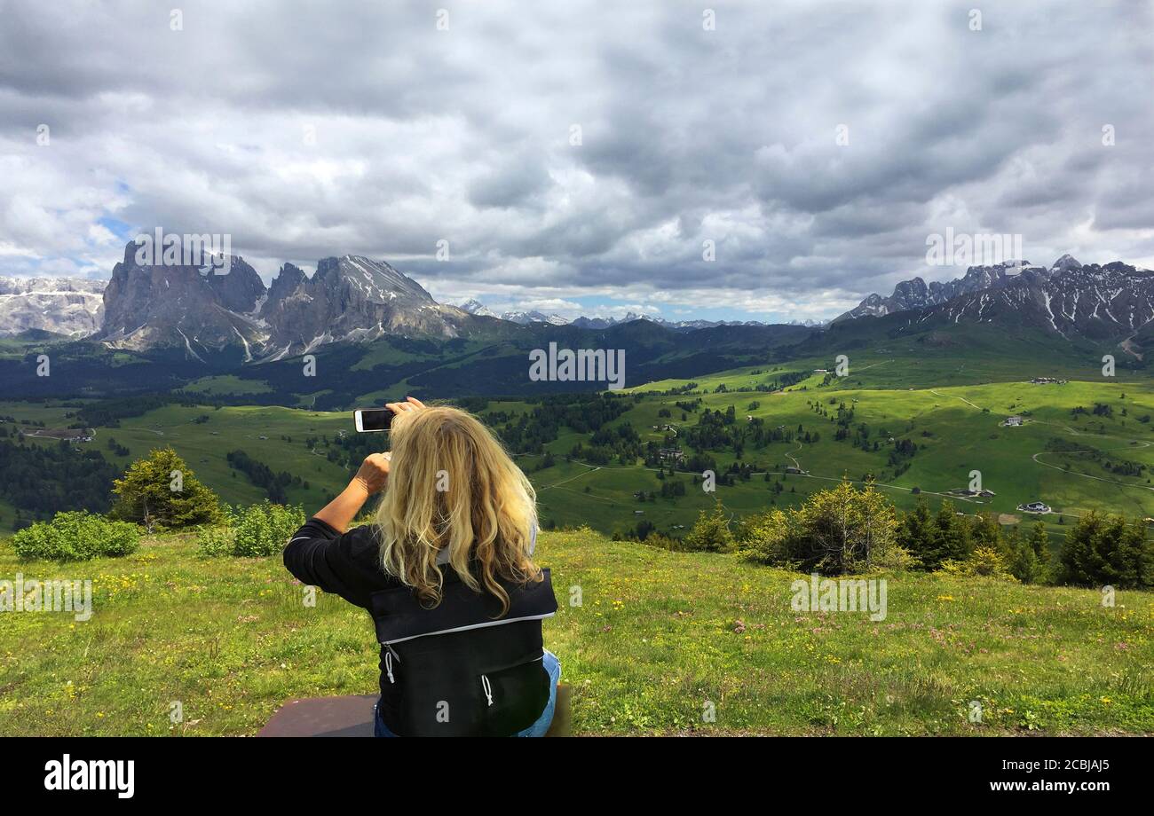 Tourist taking pictures on Seiser Alm,South Tyrol Stock Photo