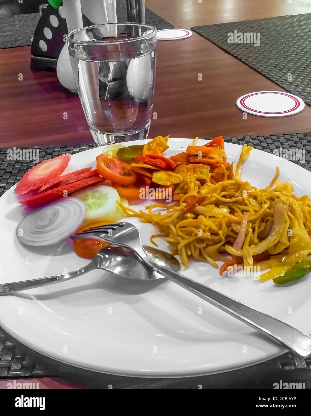 Rice noodles with carrot, capcicum and onion in a white plate background Stock Photo