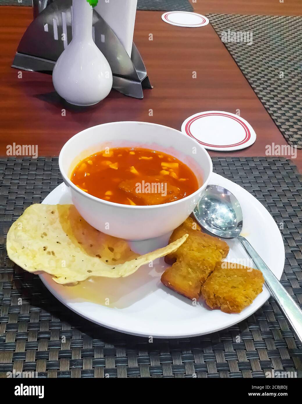 Soup on a white background  and fresh baked crusty bread rolls. Stock Photo