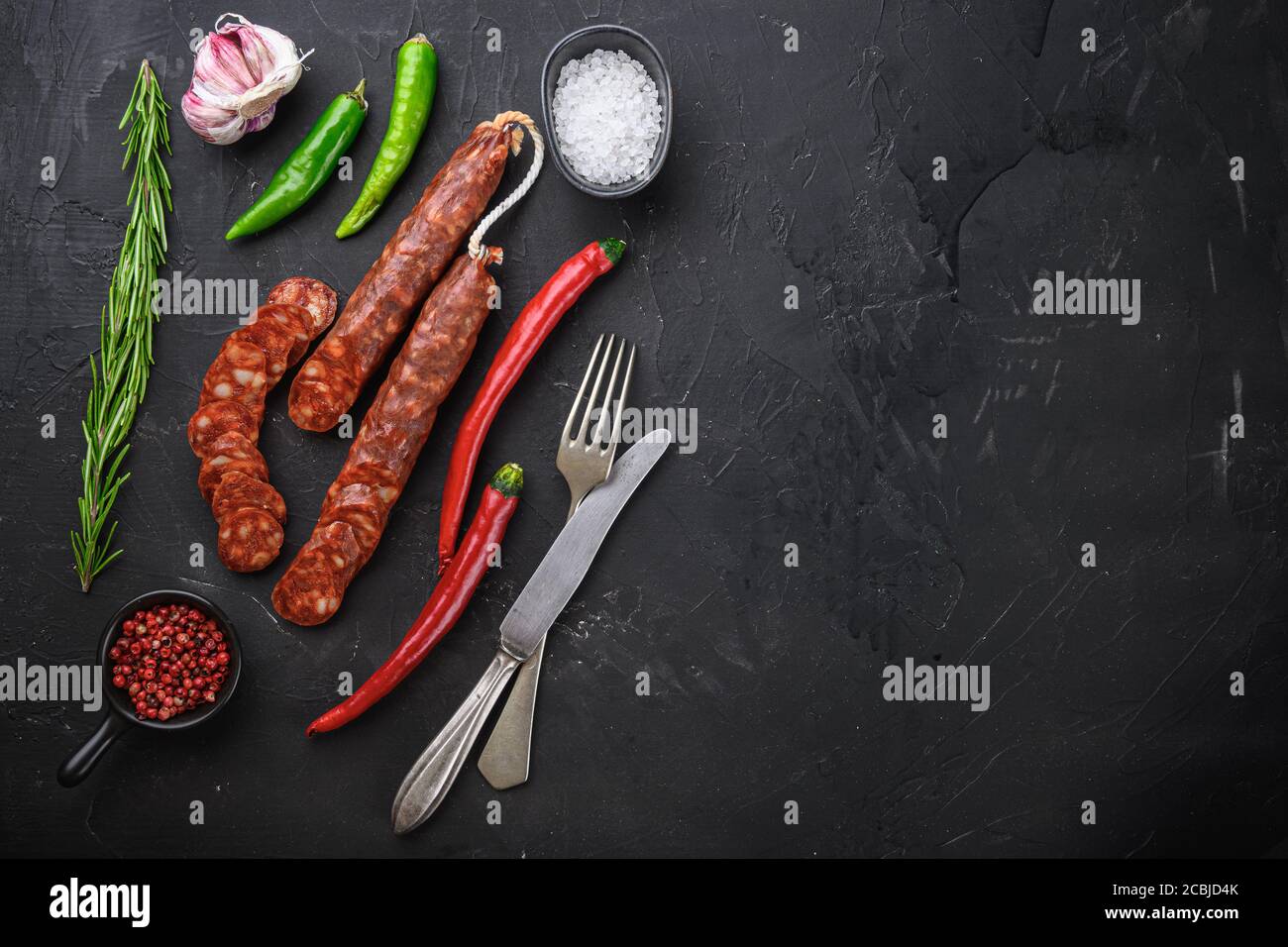 Spanish chorizo sausage slices with herbs and spices on balck ...