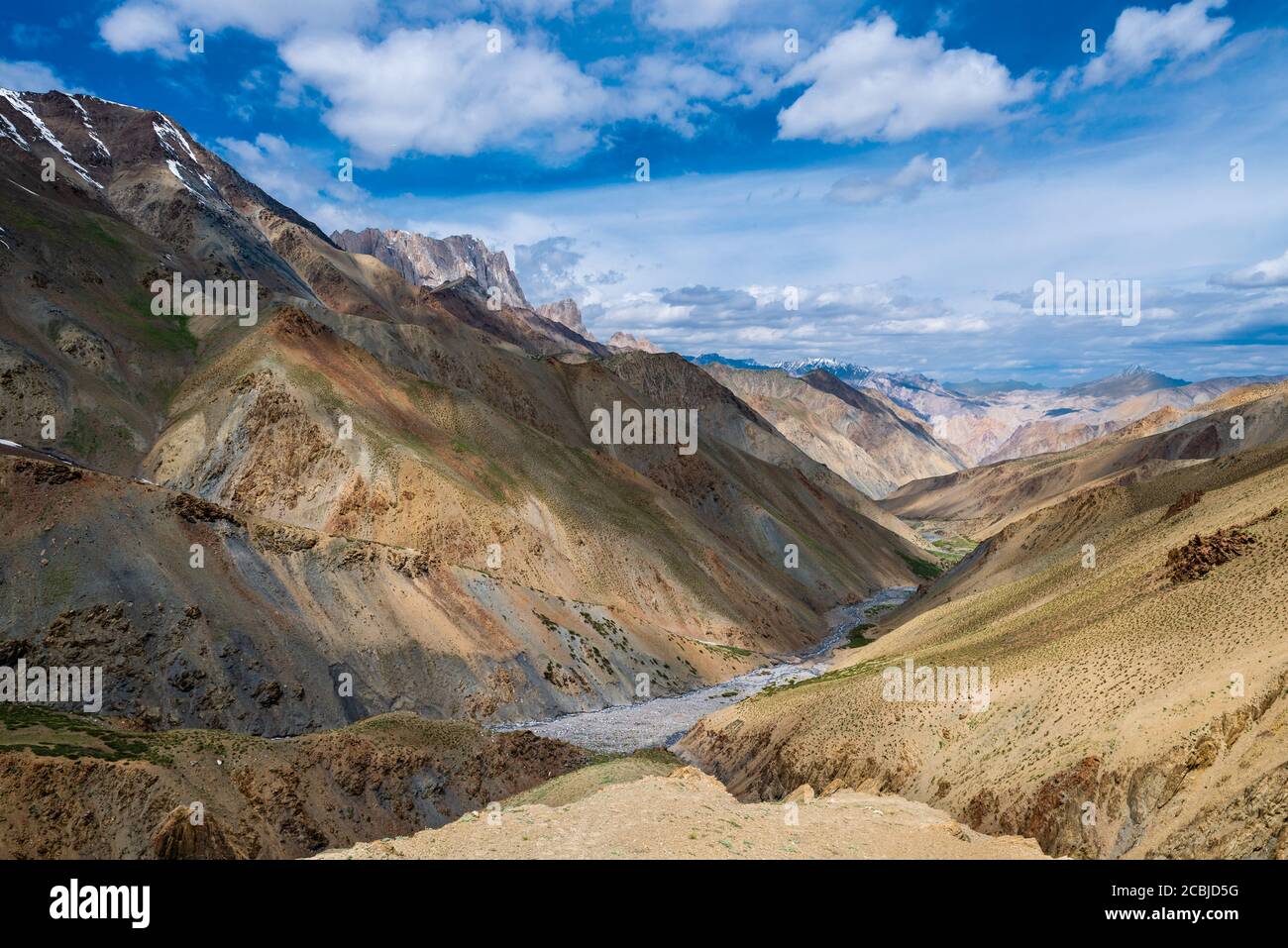 Tourist during expedition in the mountains Ladakh is admiring the beautiful Karakorum panorama Stock Photo
