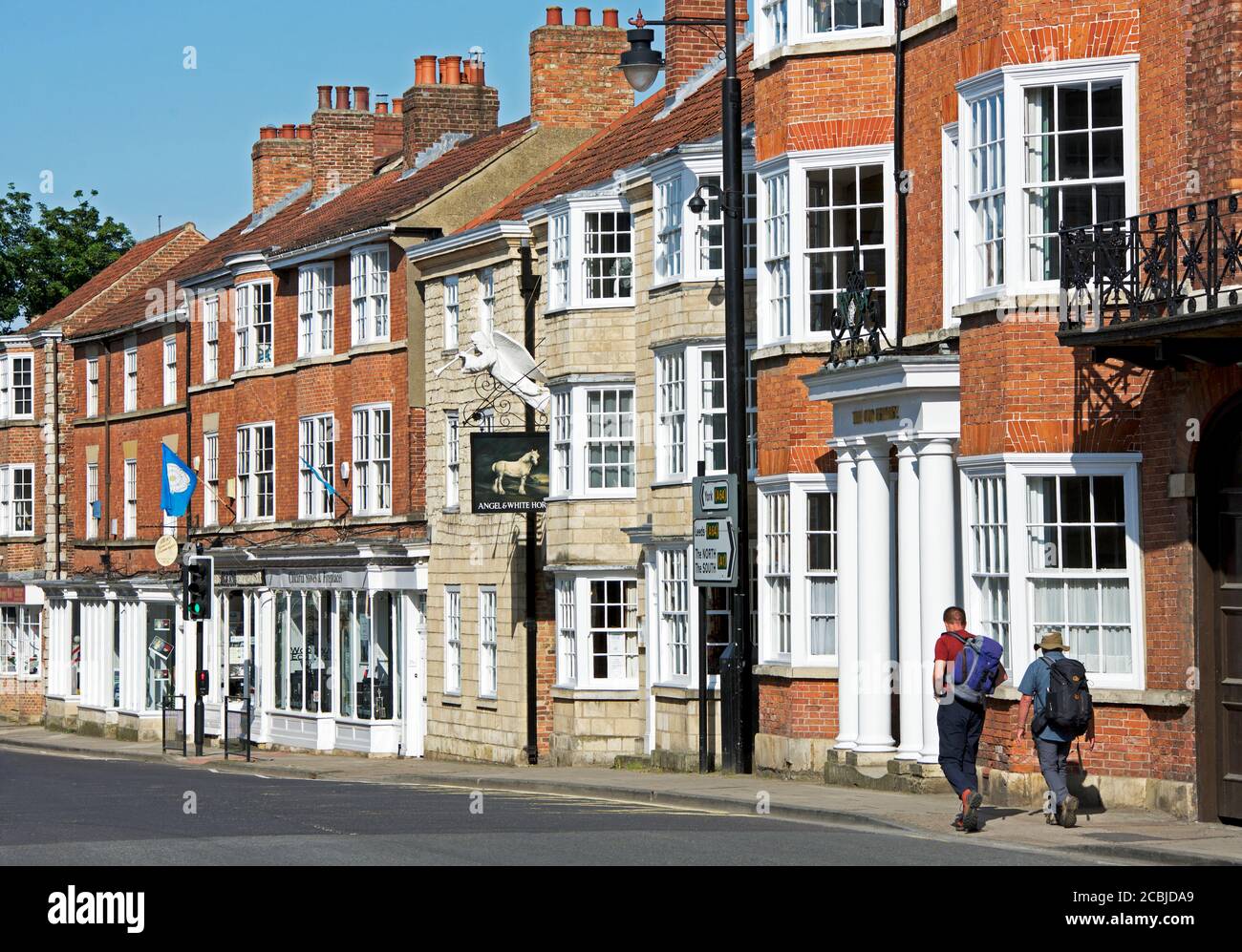 Walkers passing the Angel and White Horse pub on Bridge Street