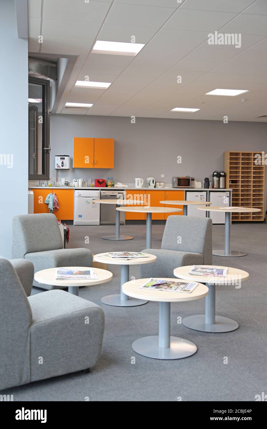 Staff room in a newly completed London secondary school. Shows kitchen area with fridges and dishwashers plus seating area in foreground. Stock Photo