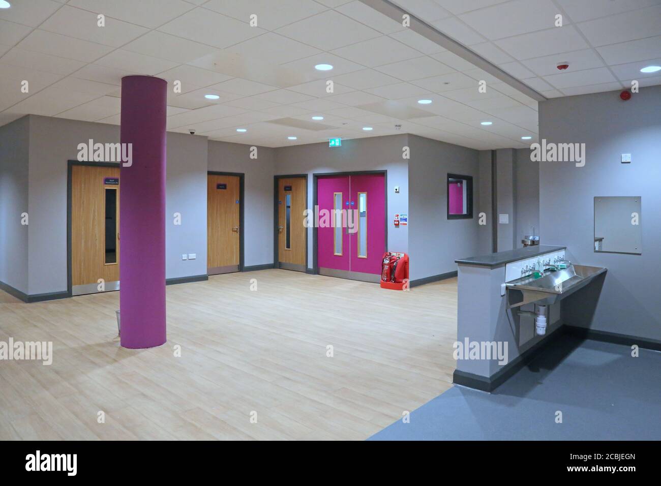 Deserted coridoor and lobby in a brand new London secondary school, shows fire doors and hand-washing area. Stock Photo