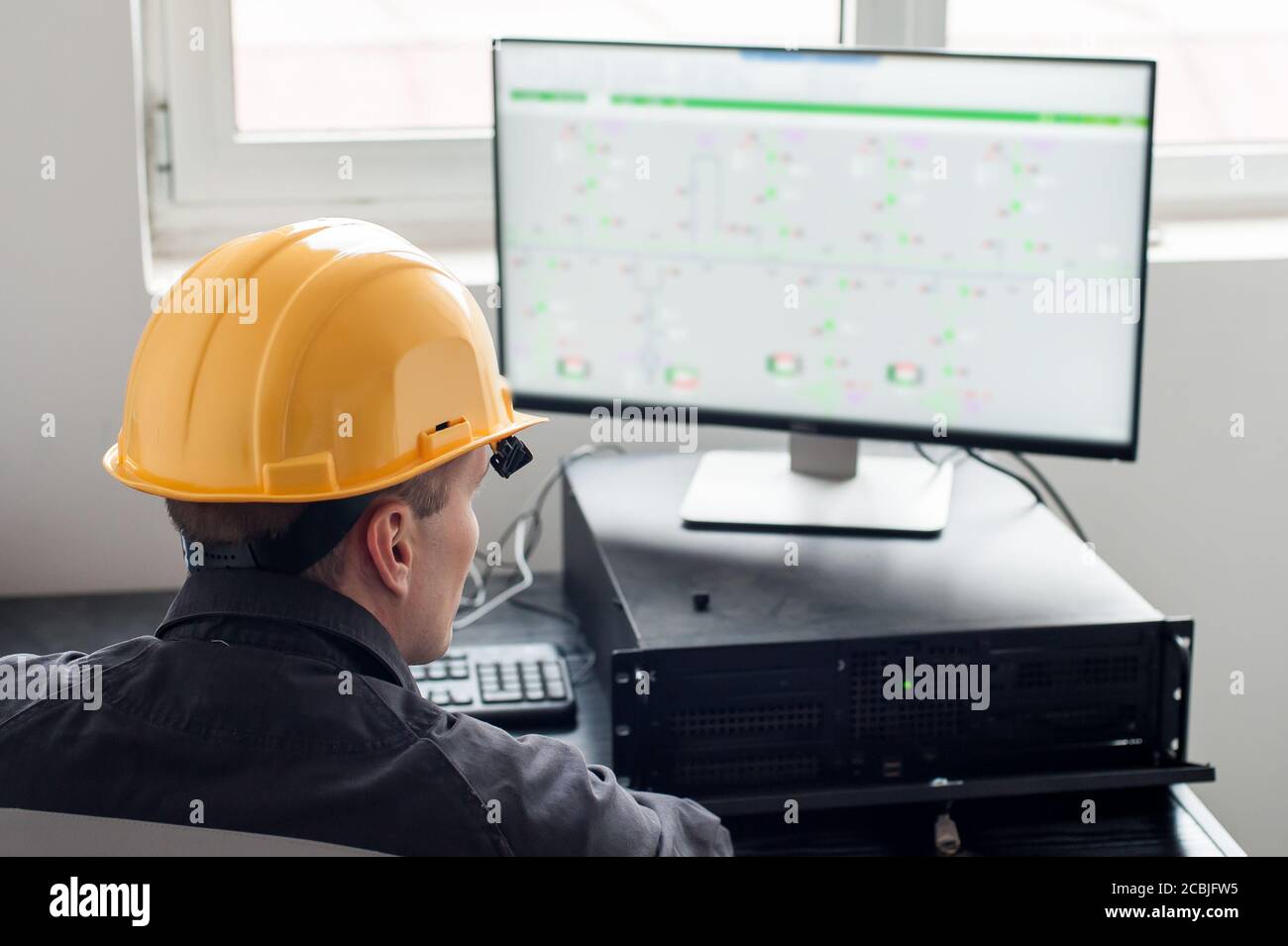 Maintenance engineer inspect relay protection system with computer. Bay control unit. Medium